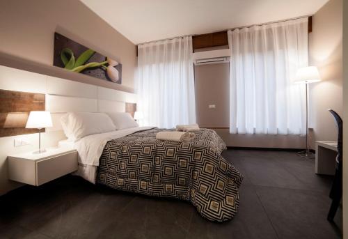 a bedroom with a large bed and a window at Living Arena in Verona