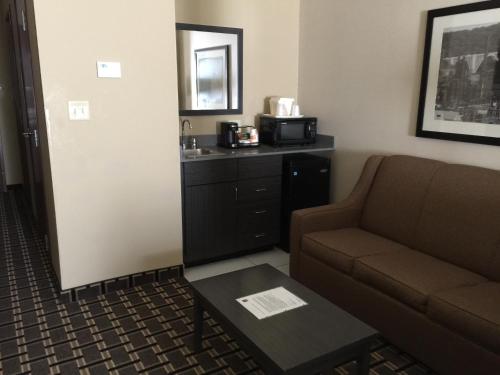 a living room with a couch and a coffee table at Comfort Suites Uniontown in Uniontown
