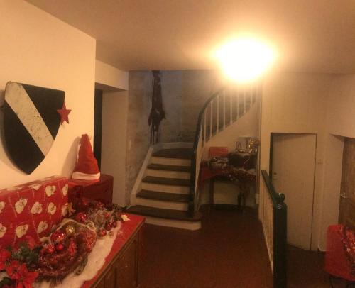 a living room with a staircase with christmas decorations at Schloß Auerbach Kleine Ferienwohnung in Bensheim