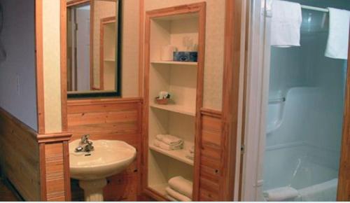a bathroom with a sink and a toilet and a shower at Dockside Motel in St. Barbe