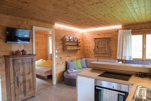 a kitchen and living room in a log cabin at Ferienhütte Premstlahof in Martello