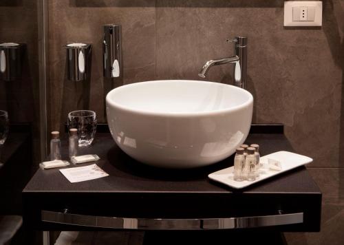 a bathroom with a large white bowl sink on a counter at Living Arena in Verona