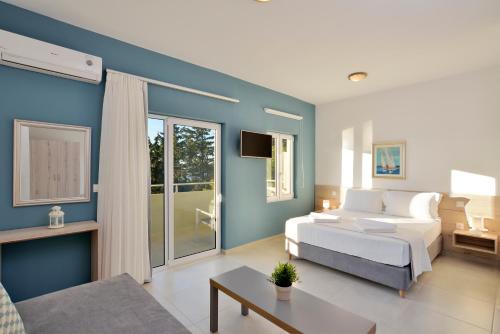 a bedroom with a white bed and a blue wall at Casa Manolesos in Chorafakia