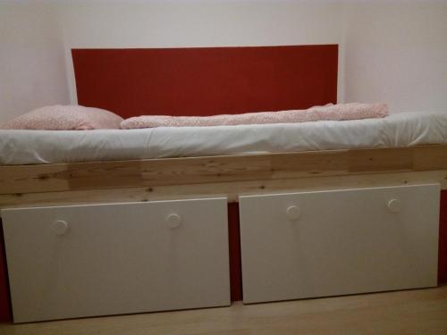 a bed with two drawers on top of it at Hostel 45 in Bonn