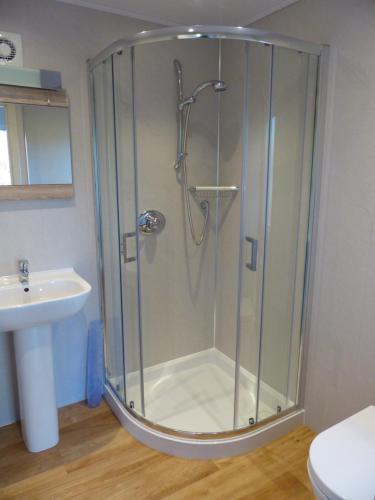 a shower stall in a bathroom with a sink at Blarghour Farm Cottages Overlooking Loch Awe in Ardchonnell