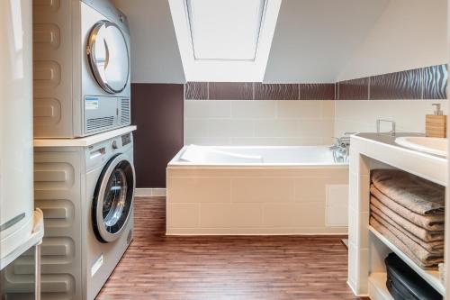 a bathroom with a washing machine and a sink at Gite "le millésime" in Épernay