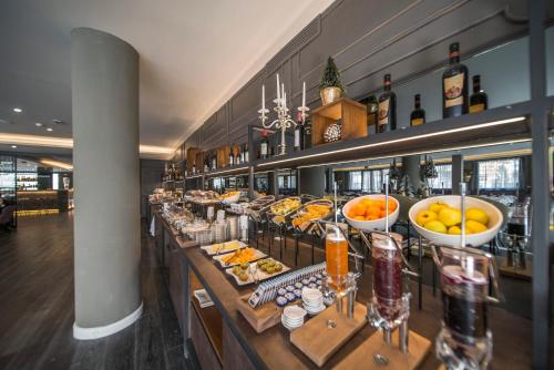 a bar with a buffet of food and drinks at Hotel Spinale in Madonna di Campiglio