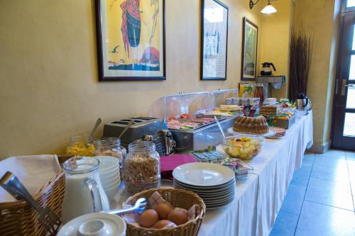 a long table with plates and food on it at Hotel Rous in Pilsen