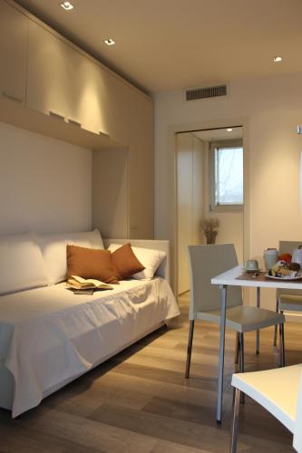a bedroom with a bed and a table and a dining room at Ca degli Artisti in Trevignano