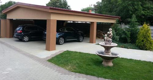 a car garage with two cars parked in it at Penzión ONE in Dolný Ohaj