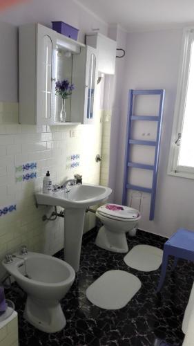 a bathroom with a sink and a toilet and a sink at DiVino in Villa Viani