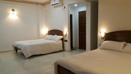 מיטה או מיטות בחדר ב-Hotel Murud Marina