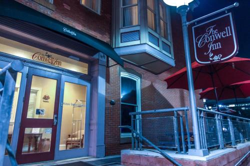 a restaurant with a red umbrella on the side of a building at The Conwell Inn in Philadelphia