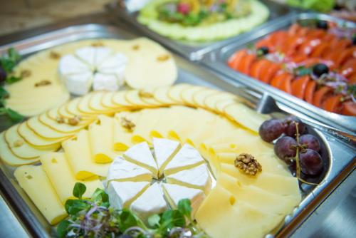 a tray filled with cheese and fruits and vegetables at Ośrodek Wypoczynkowy Marymont przy Dolinie Kościeliskiej in Kościelisko