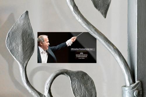 a poster of a man in a suit holding a wand at Hotel am Hofgarten in Düsseldorf