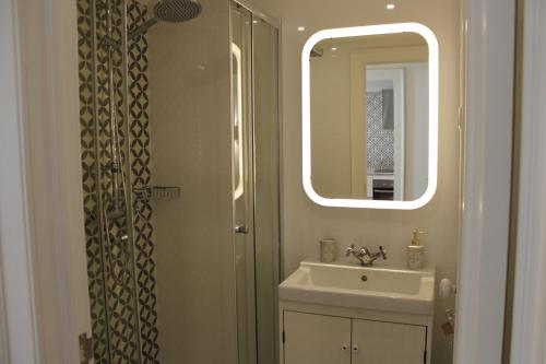 a bathroom with a sink and a mirror at Augusta Street - 4 Esq in Lisbon