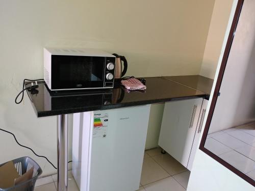 a microwave sitting on top of a counter at Hillside View Guesthouse in Coffee Bay