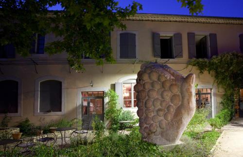 a large statue in front of a building at Logis Hotel - Restaurant La Marbrerie in Caunes-Minervois