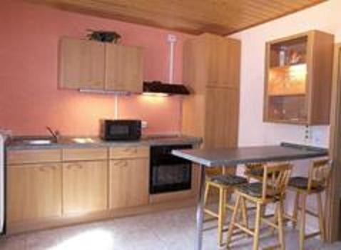 a kitchen with a table and chairs in a room at Ferienwohnung Morbach in Morbach