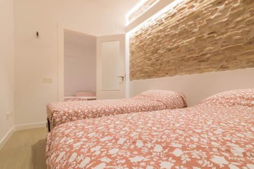 ログローニョにあるHistorical Town Sagasta Stのレンガの壁、ベッド2台が備わるベッドルーム1室が備わります。