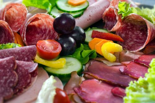a plate of food with different types of meats and vegetables at Hotel am Hofgarten in Düsseldorf