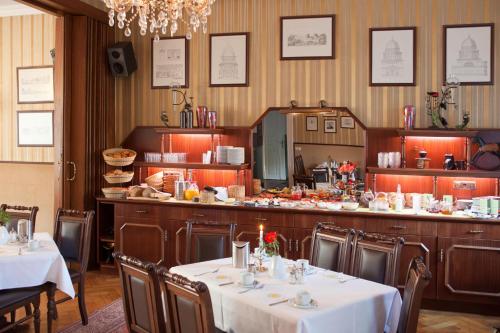 a restaurant with two tables and a bar in a room at Hotel & Restaurant Am Alten Rhin in Neuruppin