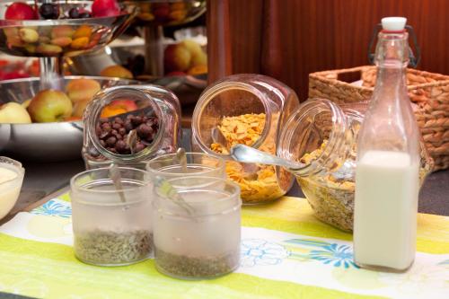 a table with glasses of milk and other food at Hotel & Restaurant Am Alten Rhin in Neuruppin