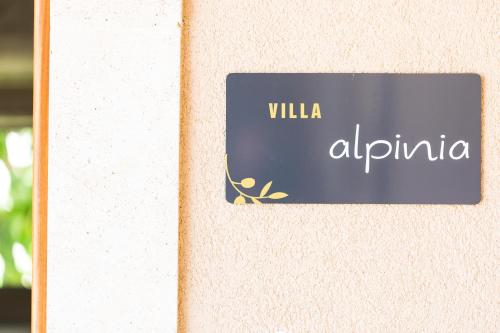 a sign on a wall that reads villa alphina at Philoxenia Villas in Panormos Rethymno