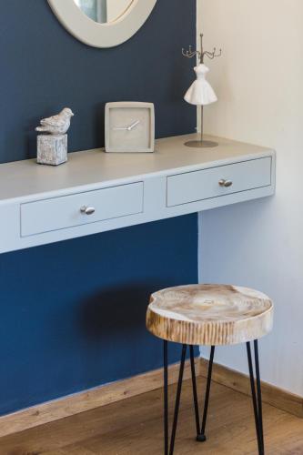 a dressing table with a stool and a mirror at Philoxenia Villas in Panormos Rethymno