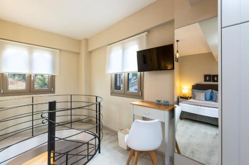 a small room with a bunk bed and a bedroom at Philoxenia Villas in Panormos Rethymno