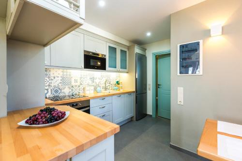 a kitchen with a bowl of fruit on a counter at Philoxenia Villas in Panormos Rethymno