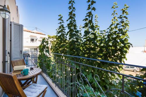 a balcony with two chairs and a plant at Philoxenia Villas in Panormos Rethymno