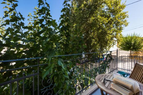 a balcony with a table and a tree at Philoxenia Villas in Panormos Rethymno