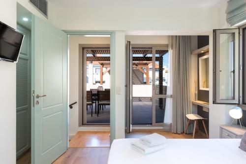 a room with a bed and a view of a dining room at Philoxenia Villas in Panormos Rethymno