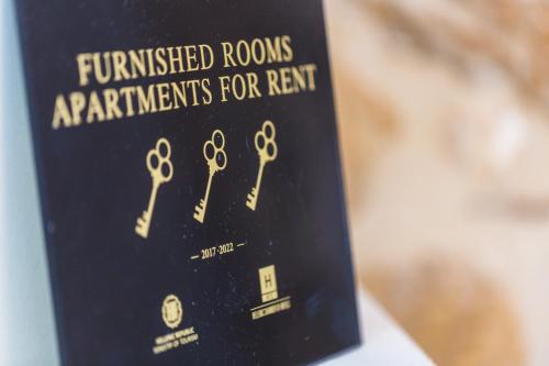 a book with a bunch of gold keys on it at Philoxenia Villas in Panormos Rethymno