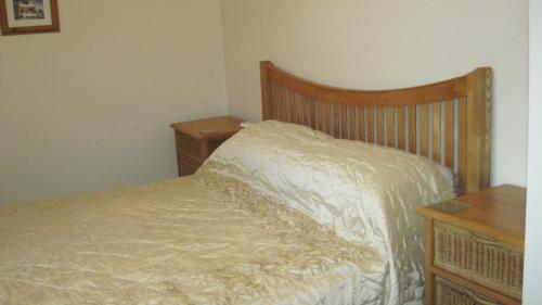 a bedroom with a bed and two night stands at Glengarth in Penryn