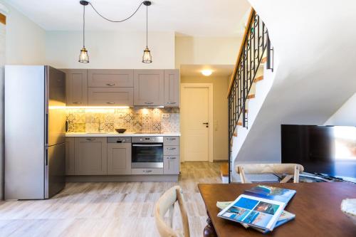 a kitchen with a table and a refrigerator at Philoxenia Villas in Panormos Rethymno