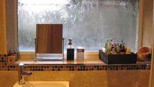 a bathroom counter with a sink and a mirror at Glengarth in Penryn