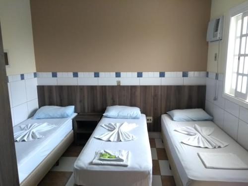 A bed or beds in a room at Ville House Hotel Canoas