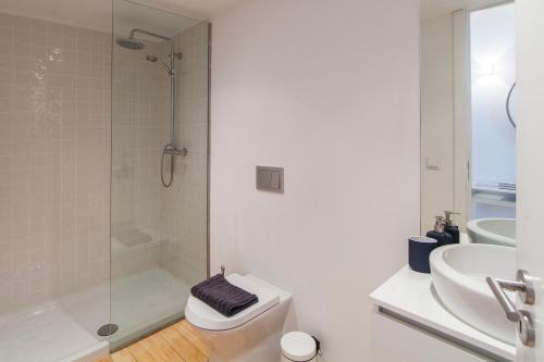 a bathroom with a shower and a toilet and a sink at Oporto Mezzanine - by ML Apartments in Porto