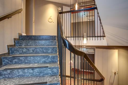 a stairway with blue marble steps and a chandelier at Vienna House Easy by Wyndham Hamburg City in Hamburg