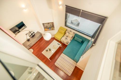 an overhead view of a living room with a yellow couch at Pleiades Boutique Villas in Kriopigi