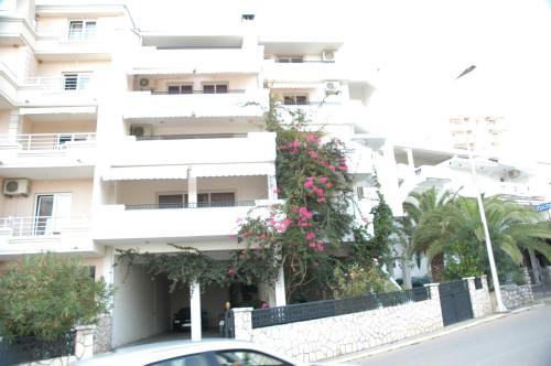 a white building with pink flowers in front of it at Villa Dulsinea in Ulcinj
