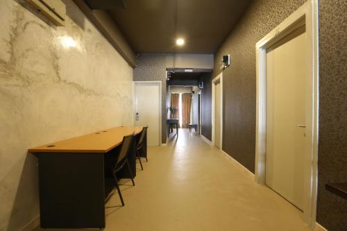 a hallway with a long table and chairs in a room at SK Guesthouse Selayang in Batu Caves