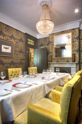 a dining room with a long table with chairs and a chandelier at Lilianfels Blue Mountains Resort & Spa in Katoomba