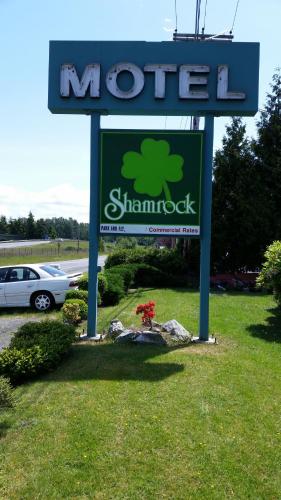 a sign for a morocco dealership in a field at Shamrock Motel in Bellingham