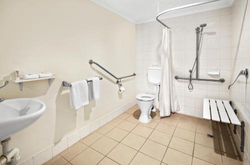 a bathroom with a toilet and a sink at Quest Mont Albert in Box Hill