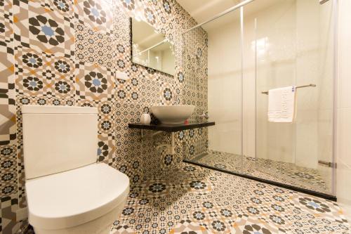 a bathroom with a toilet and a shower at 台南安平民宿幸福拾光 in Tainan