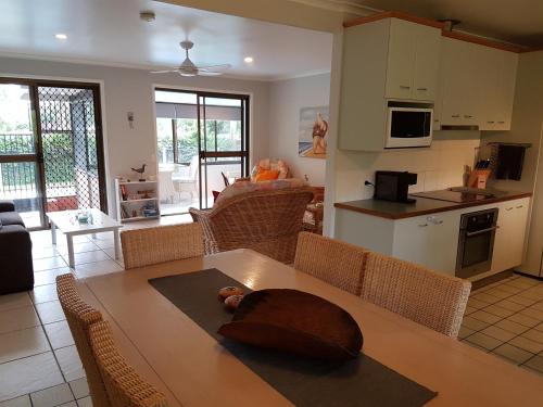 a kitchen and living room with a table and chairs at Beerwah House in Beerwah