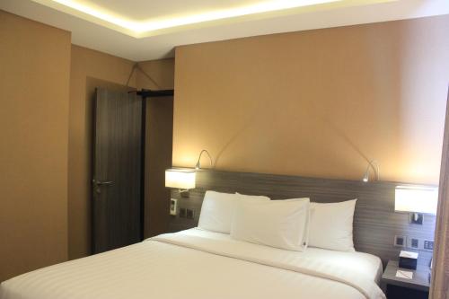 Katil atau katil-katil dalam bilik di Biz Hotel Batam